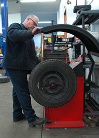 Car mechanic working on tire